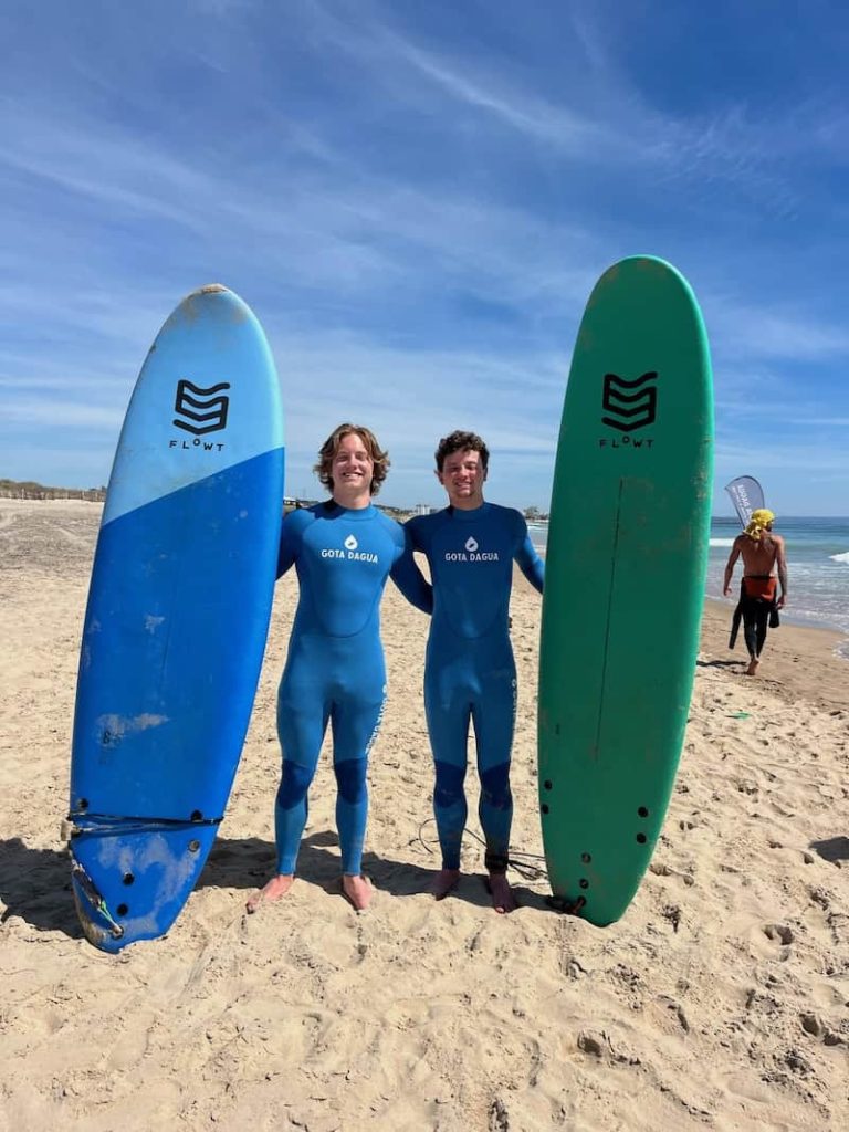 Surf lesson Costa da Caparica two young surfers posing with surf boards