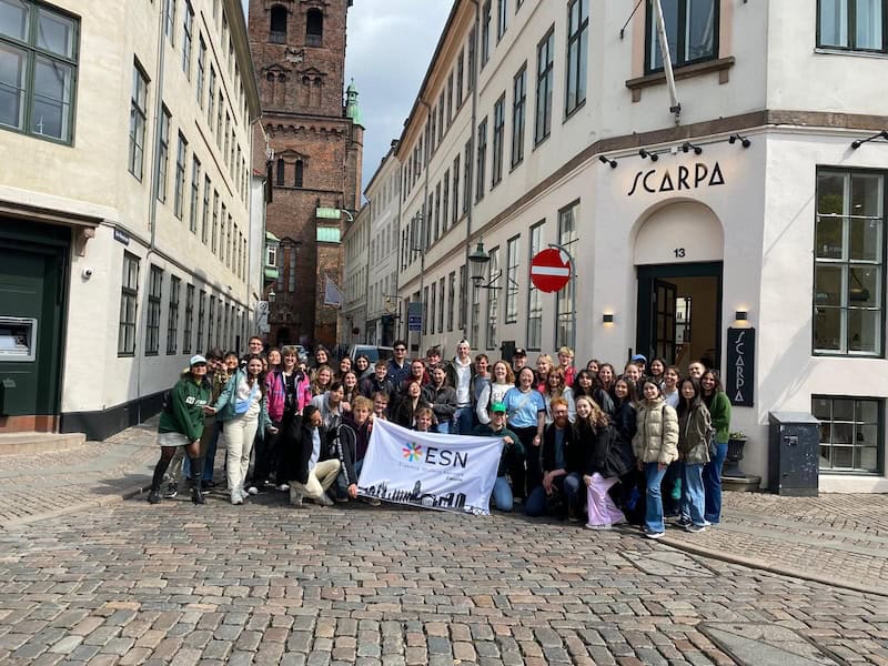 ESN group on a city tour in Copenhagen holding ESN banner
